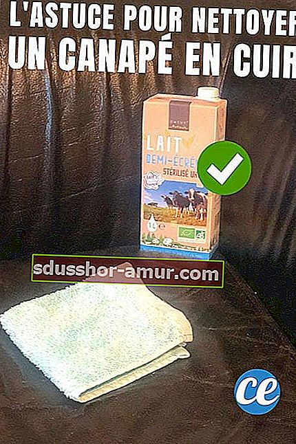 Karton mlijeka na crnoj kožnoj sofi za čišćenje