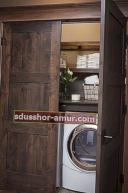Prostor za pranje rublja skriven iza drvenih vrata